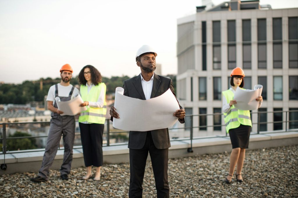 Diverse architects meeting in open air for plan discussion